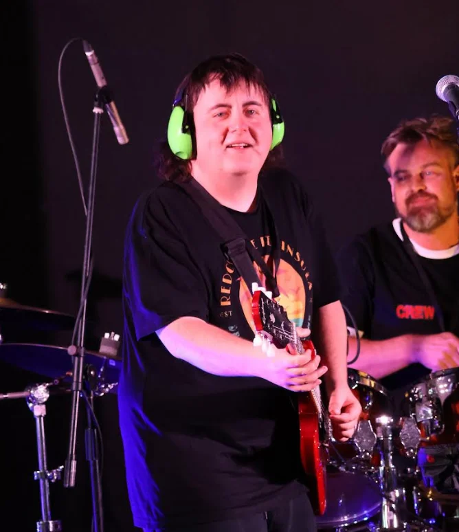 Musician performing on stage at Dolphins Leagues Club